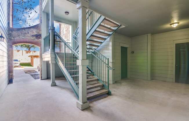 a spiral staircase on the second floor of a house with a door