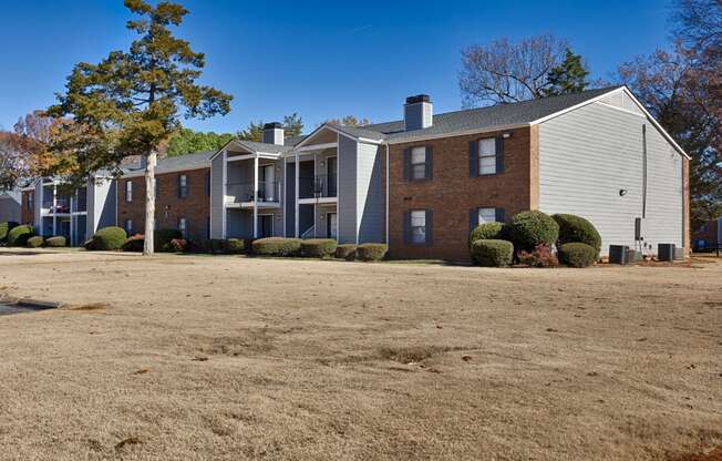 A large building with a grey roof and a white garage door.