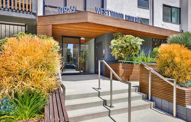A building with a wooden entrance and steps leading up to it.