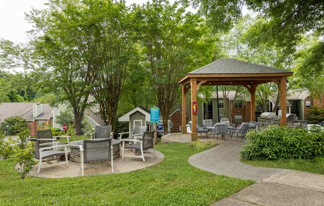 a pavilion with tables and chairs in a garden