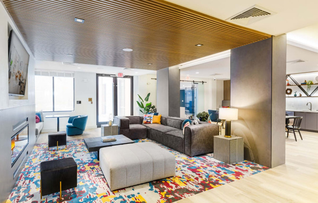 a living room with couches and chairs and a rug at One Ten Apartments, New Jersey