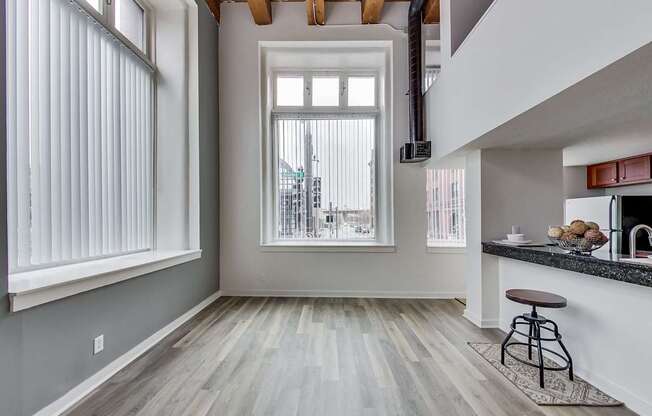 A kitchen with a bar stool and a window overlooking a street at Lowertown Commons Apartments, Minnesota