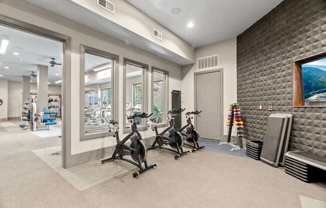 A room with a treadmill and exercise bike.