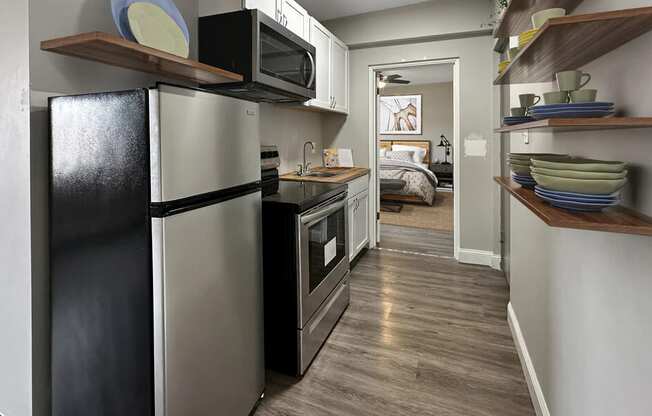 a kitchen with a refrigerator and a microwave