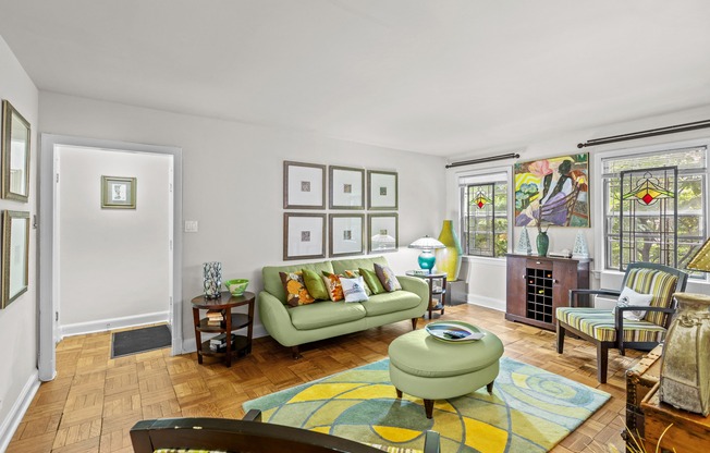 a living room with a green couch and a fireplace