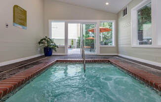 a home with an indoor pool and an open door