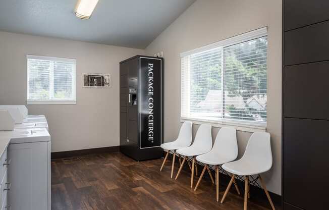 a room with a fridge and chairs