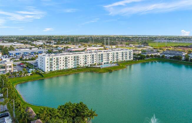 an aerial view of a large lake with apartments in the background