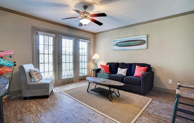 a living room filled with furniture and a large window