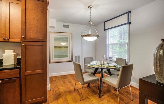 a dining room with a table and chairs