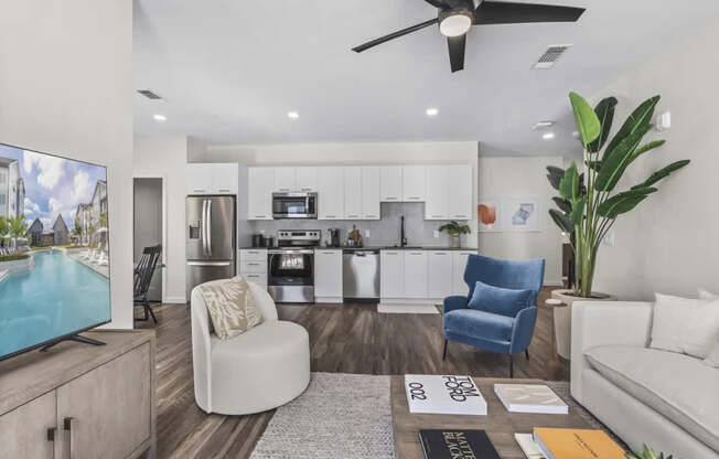 A modern living room with a television, sofas, and a plant.
