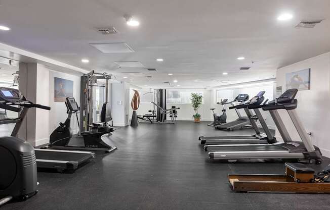 A spacious gym with treadmills, elliptical machines, and other exercise equipment.