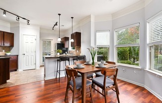 an open kitchen and dining room with a table and chairs at Sovereign at Overland Park, Overland Park  
