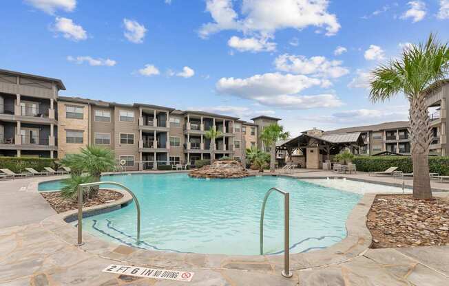 A swimming pool surrounded by apartment buildings.