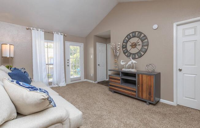 a living room filled with furniture and a large window