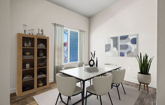 A dining room with a table and chairs.