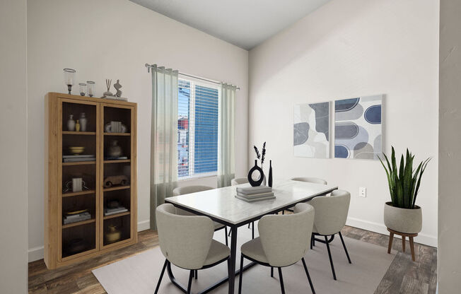 A dining room with a table and chairs.