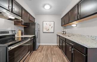 Spacious Kitchen  with stainless steel appliances and dark cabinets at Lakeside Village Apartments Clinton Township, MI