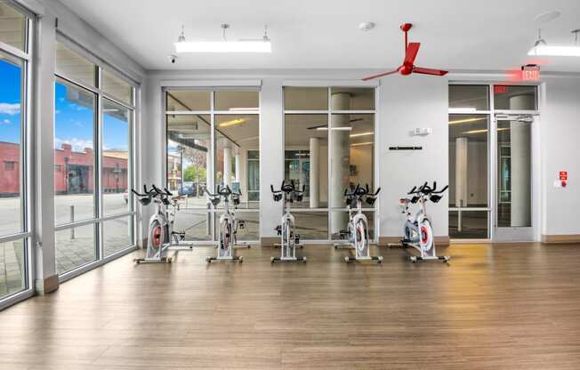 the gym with treadmills and ellipticals at the belgard apartments at South Side Flats, Dallas, TX