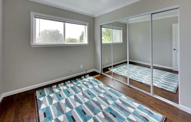 bedroom with mirrored closet doors at THE POST Apartments, PLEASANT HILL , CA