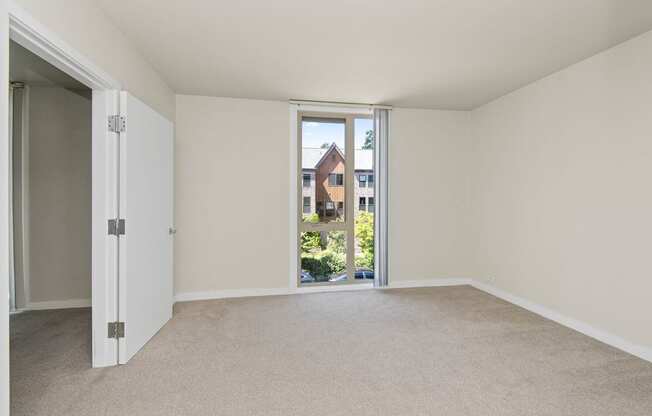 a bedroom with an open door and a carpeted floor at Cosmopolitan, Washington