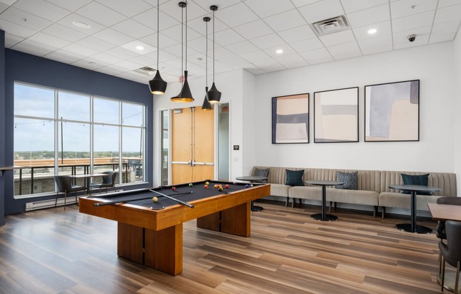 an open room with a pool table and couches