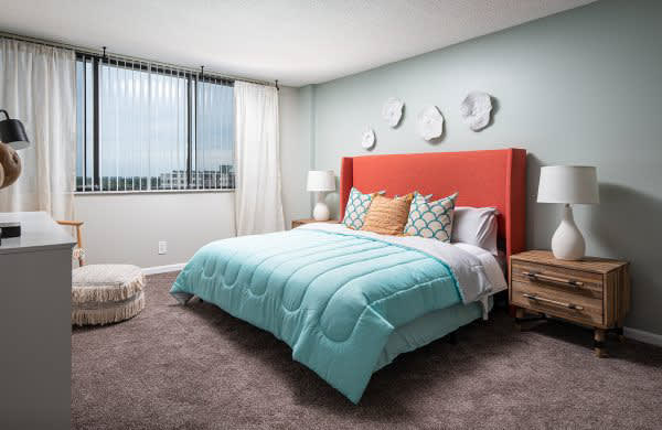 a bedroom with a bed with a blue comforter at Fairways of Inverrary, Lauderhill, FL