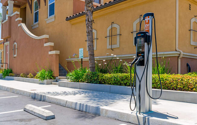 A charging station for electric vehicles is located in front of a building.