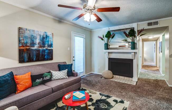 a living room with a couch and a ceiling fan