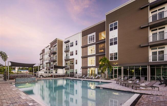 a large swimming pool in front of some apartment buildings