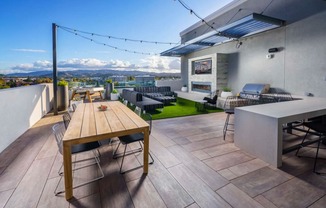 a terrace with a wooden table and chairs at NoMa Apartments, California, 94596