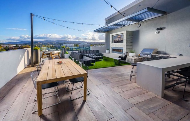 a terrace with a wooden table and chairs at NoMa Apartments, California, 94596