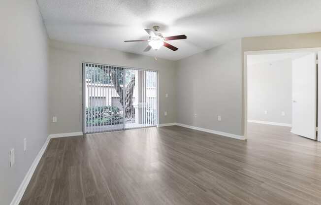 an empty living room with a ceiling fan and a window at Pembroke Pines Landings, Florida