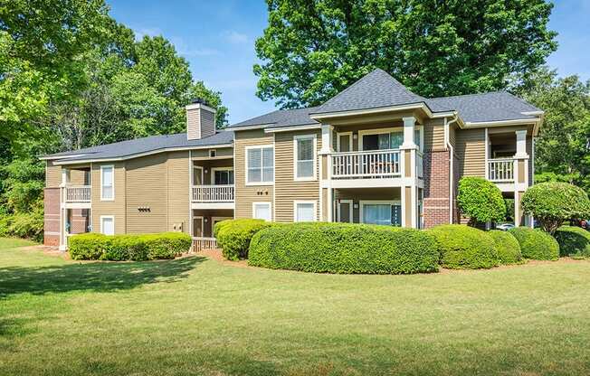 Exterior Of Apartment Homes Overlooking Lush Grass Area