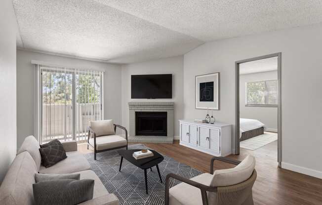a living room with a couch and a chair and a fireplace at Verona, Colorado, 80123