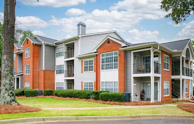 an apartment building with red brick and white siding at Twenty35 at Timothy Woods, Athens, 30606