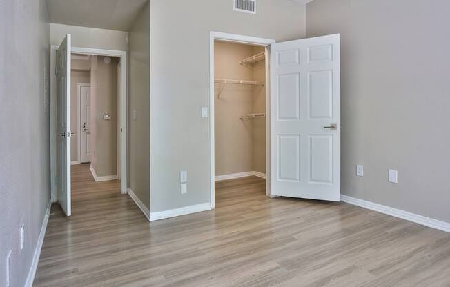 A room with a white door and a white interior wall.