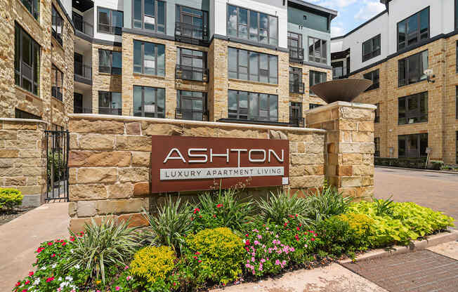 an exterior view of an apartment building with a sign luxury apartment living