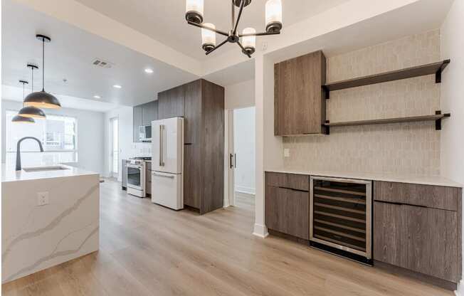 A modern kitchen with a refrigerator, oven, and a countertop.