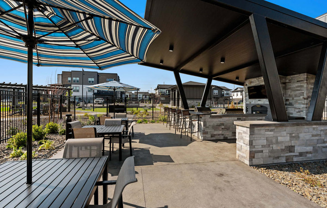 a patio with tables and chairs and umbrellas