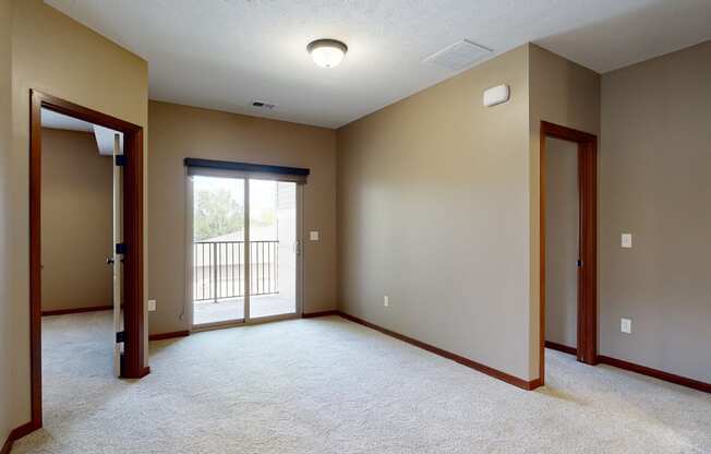 a living room with a sliding glass door to the balcony