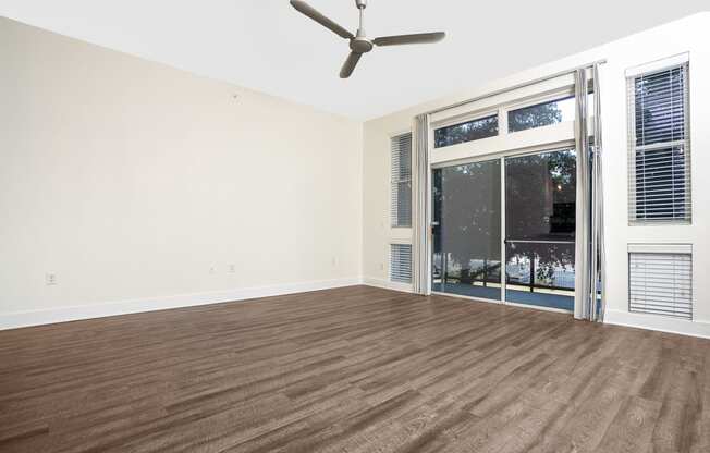 a bedroom with hardwood floors and a ceiling fan