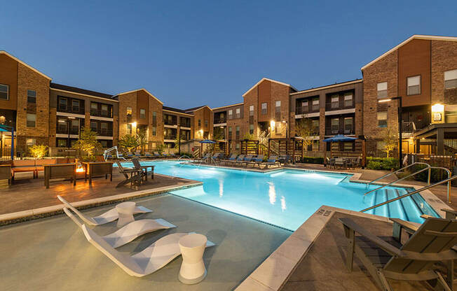 Community Swimming Pool with Pool Furniture at Alta 3Eighty Apartments located in Aubrey, TX.