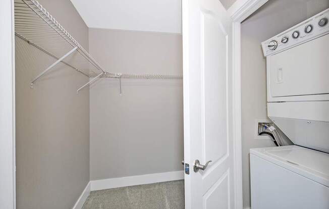 A white oven is in a kitchen next to a closet.