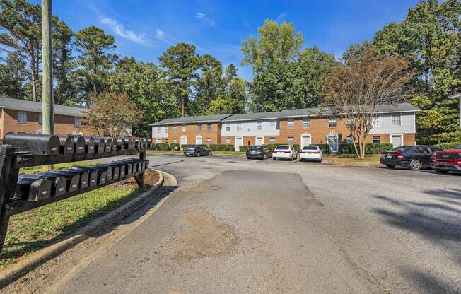 a parking lot with cars in front of a brick building
