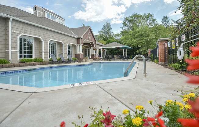 Outdoor Pool Surrounded by Sundeck and Manicured Landscaping