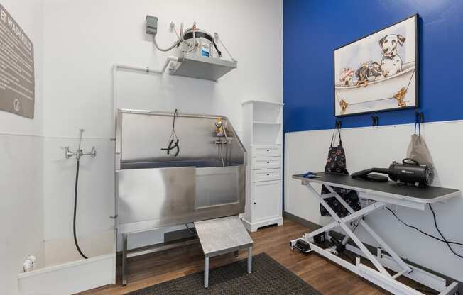 a small room with a sink and a table and a refrigerator