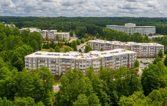 A large building complex surrounded by trees.