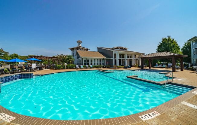 a large swimming pool with a building in the background