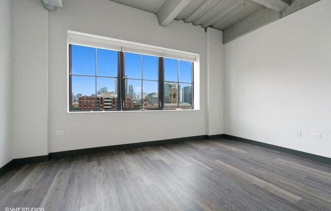 an empty living room with a large window